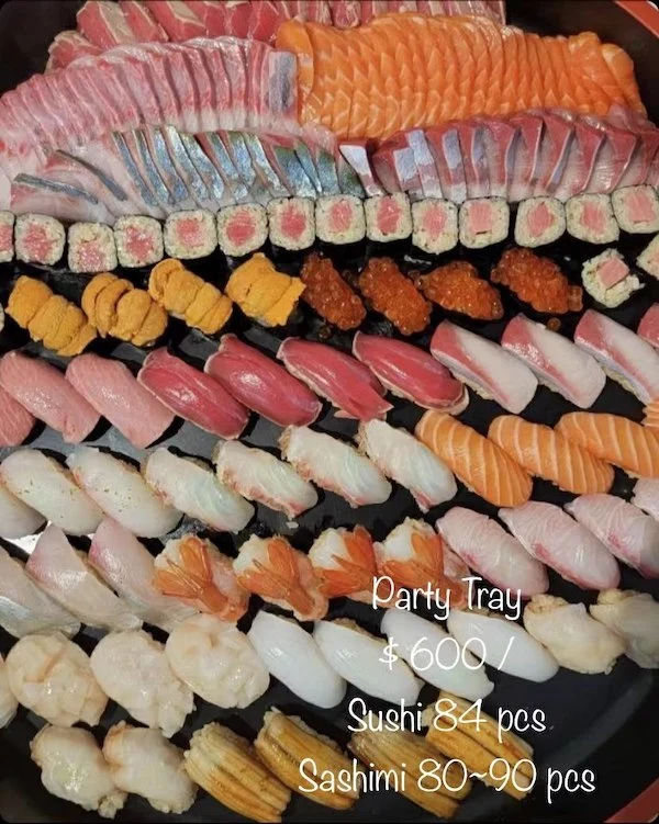 Large assortment of various sashimi, sushi, and maki